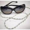 A chain for glasses made of blue glass stones and beige between them.