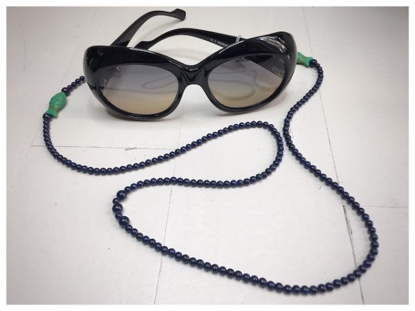 Dark blue stones and green fish chain.