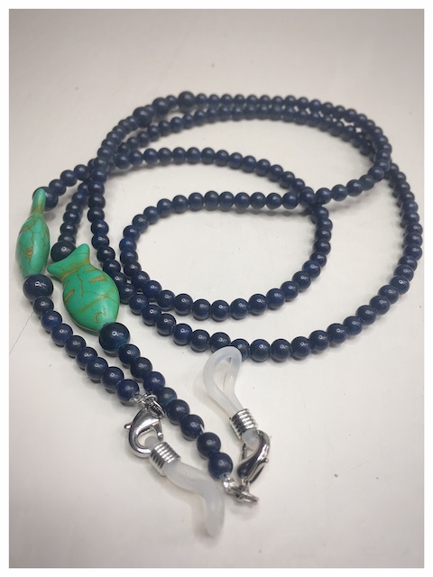 A chain for glasses made of navy blue stones with green fish.