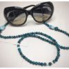 A chain for glasses of turquoise color with a white-turquoise larger stone.