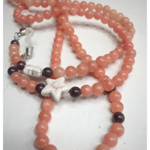 An orange eyeglass chain with a beige star and dark beads around it.