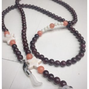 A chain for glasses made of maroon stones with beige stars between orange stones.